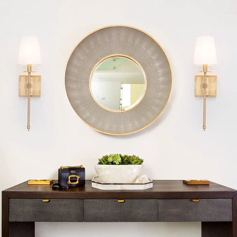 Room with sleek modern wall sconces in antique brass brush finish with white fabric shade, slim metal fixture for bedroom hallway entryway