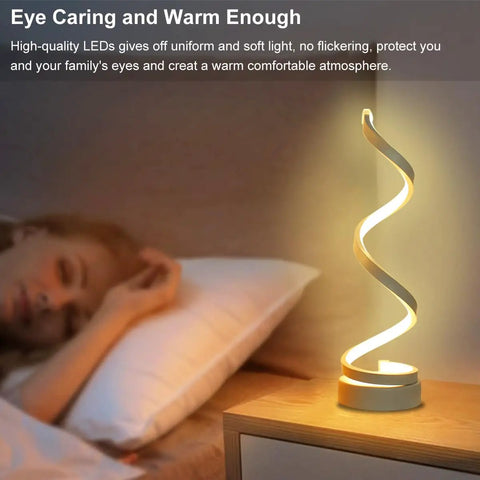 Spiral LED Desk Lamps Set Of 2 10W Modern Bedside Lights with warm glow on nightstand next to sleeping person in bedroom.