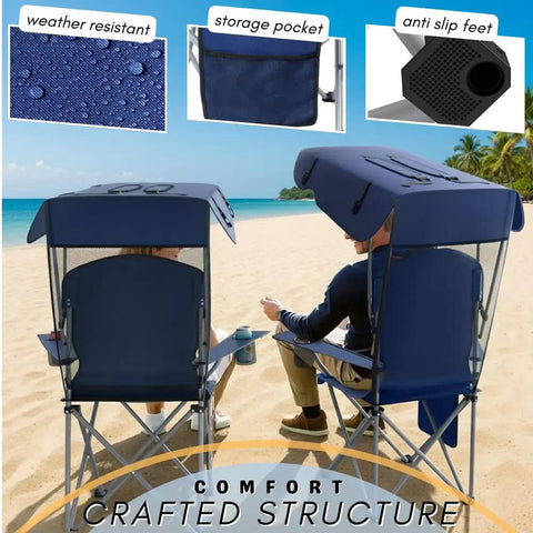 Navy Portable Folding Camping Chair With Detachable Canopy Shade For Outdoors Beach And Lawn in use on sandy beach.