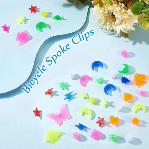 Plastic Bike Spoke Beads Set With 7 Styles In Assorted Colors, About 280 Pcs, showing star, moon, butterfly, heart, bolt shapes on blue surface