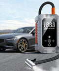 Portable Wireless Tire Inflator With Digital Pressure Gauge No Sweat Air Compressor For Cars Motorcycles Bikes And Balls Road Trip Ready Quick Fix next to a stylish gray car.
