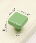 Glossy Ceramic Square Cabinet Knobs 1.25 Inch Green Six Pack Kid Friendly with dimensions on wood surface