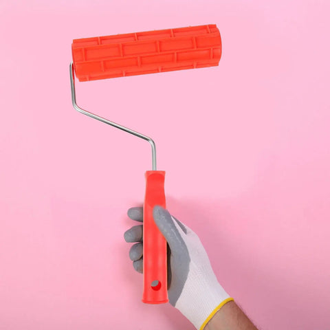 Top Shelf Rubber Textured Paint Roller With Kick Butt Spiked Surface For Walls Floors And Furniture Refinishing held in hand.
