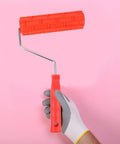 Top Tier Embossing Rubber Paint Roller For Creations That Slay With Epic Wall Textures And Cool Graining Patterns, handheld on pink background.