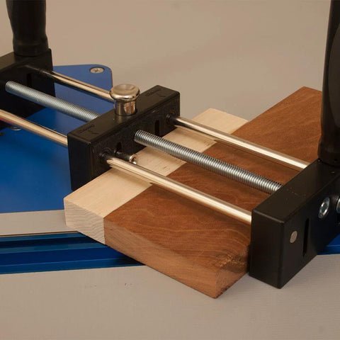 Small Stock Holder for Router Tables that secures tiny wood pieces, showing mechanism holding two wood pieces for precise cuts