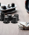 Five Piece Jewelers Loupe Set With Holder 3X 5X 10X 15X 20X Monocular Magnifiers on table with watch gears
