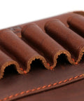 Close-up of Genuine Leather Buttstock Cheek Rest with Rifle Shell Holder, showing brown leather ammo slots and stitching detail.