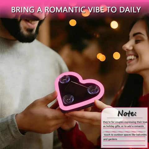 Couple holding Solar Powered Heart Light For Cars Wireless LED Ambient Lamp with suction cups, pink heart shape.