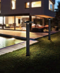 Two Solar Landscape Path Lights Outdoor Motion Sensor Garden LED Light Aluminum Waterproof in black illuminating walkway by house