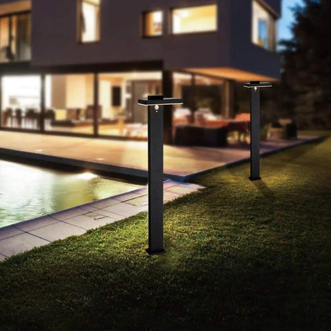 Two Solar Landscape Path Lights Outdoor Motion Sensor Garden LED Light Aluminum Waterproof in black illuminating walkway by house