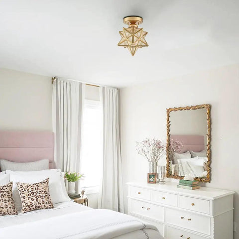 Modern Sleek Brass Moravian Star Ceiling Light Mini Semi Flush Mount With 8 Inch Seeded Glass in elegant bedroom setting