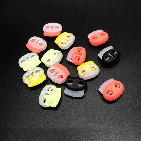 30 Pack Adjustable Button Spring Buckles Plastic Rope Locks With Toggle Fasteners Go To DIY Gear Multi Purpose Snap Joints For DIY Projects And Clothing, Fits Hoodies Sweatpants Jackets Backpacks Five Random Colors. assorted plastic rope lock buckles on black background