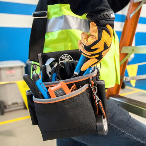 Tradesman Pro Tool Pouch With Padded Shoulder Strap And Reinforced Bottoms 15 Pocket Tool Organizer worn by worker on ladder.