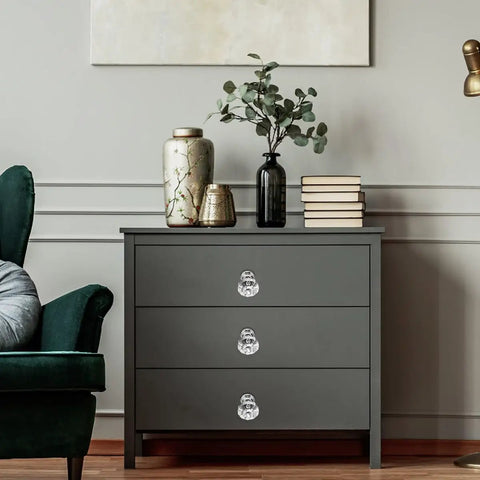 Gray dresser with Crystal Acrylic Cabinet Knobs With Silver Base, 10 Pack Modern Drawer Pulls For Home Decor And Kitchen Storage installed.