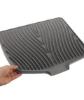 Legit Heavy Duty Silicone Countertop Drying Mat For Kitchen And Bar With Non Slip Grip, grooved gray silicone mat held in hand.