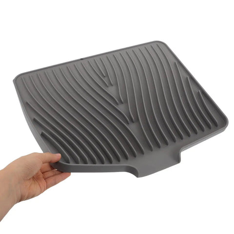 Legit Heavy Duty Silicone Countertop Drying Mat For Kitchen And Bar With Non Slip Grip, grooved gray silicone mat held in hand.