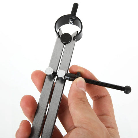 Close-up of an 8-inch divider caliper with screw adjustment and metal legs, held in hand