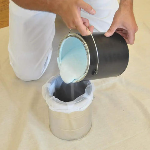 Person pouring liquid into a 1-gallon pail using Regular Mesh Bag Strainers For 1 Gallon Pails Elastic Top 25 Pack 600 Micron White Filters