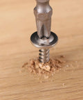 Close-up of Built Like A Tank 500 Pack Of 8 X 1/2 Sheet Metal Screws being driven into wood with a drill bit.
