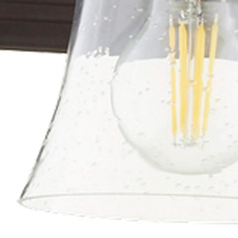 Seeded glass bulb detail of Transitional Five Light Vanity Fixture in Oiled Bronze with Clear and Seeded Glass Damp Rated Bathroom Lighting