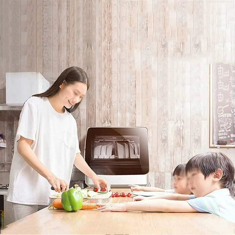 Freestanding Countertop Dishwasher With Auto Dry Storage And Snappy Touch Controls For Rapid Cleaning Cycles high Temp Sterilization And Smart Power Savings in a kitchen with a woman preparing food.