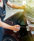 Mechanic using Dry Film Moly Lube For Metal To Metal Contacts, High Temp Up To 750 Degree Fahrenheit, on car door hinge