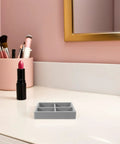 Ultra Plush Velvet Jewelry Organizer Tray With Four Secure Compartments To Keep Rings And Earrings Locked In Place on a vanity.