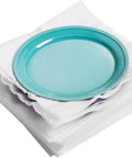 A teal plate resting on a stack of 100 Cushion Foam Pouches And Sheets For Moving Protect Fragile Stuff Like Mugs Cups Glasses China And Dishes.