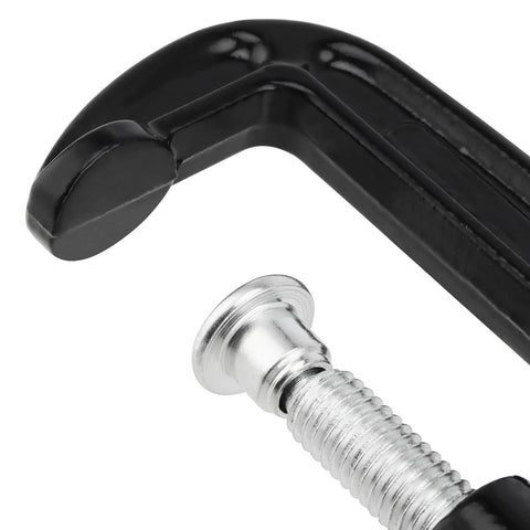 Fifteen Piece 2 Inch G Clamp Set Black Metal C Clamps With 50mm Jaw Opening For Woodworking Metalworking And Assembly Projects Great For Welding And Fastening Heavy Duty Cast Iron Frame Delivers Strong Grip And Smooth Clamping. close-up of black cast iron G clamp with threaded screw