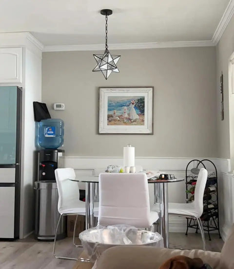 14 Inch Star Pendant Light With Seeded Glass Shade in modern dining area with adjustable hanging chain.