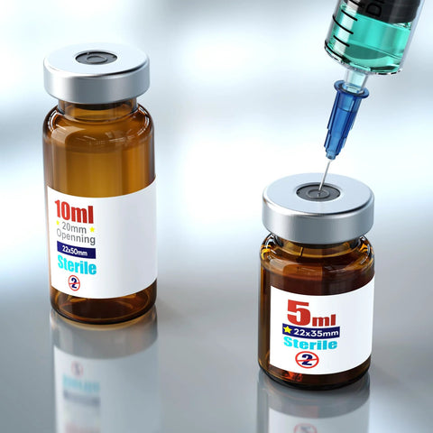 Front view of two amber glass sterile vials with aluminum caps, 10 ml and 5 ml, syringe at injection port.