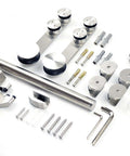 Heavy Duty Stainless Steel Glass Sliding Barn Door Hardware Kit For 8 Foot Doors With Brushed Finish Fits 8 Or 10mm Glass Supports Up To 90 Kg Hardware Only Includes Rollers 4 Feet Tracks Track Connectors Wall Connectors End Caps Floor Guide And Knob laid out on surface with tools.