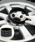Premium Slick Car Wheel Hub Center Rings 4 Pack Adapts 73.1Mm Outer To 64.1Mm Inner Bore placed on a silver alloy wheel.