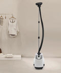 Pro Grade Garment Steamer 110V 1500W With Adjustable Steam Temperature in white, shown in a room with clothes rack and accessories.