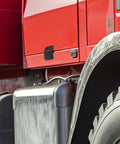 Close-up of a red vehicle's side panel and wheel, showcasing the detail of heavy-duty gate hardware install area.