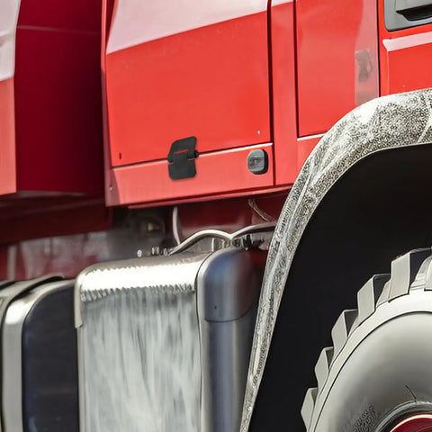 Close-up of a truck with a focus on the detailing and exterior features near the wheel.