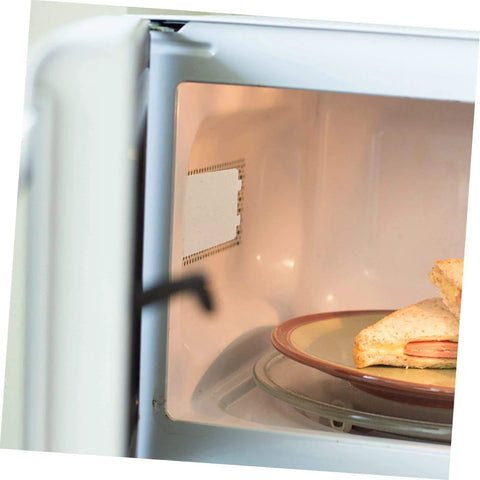 Close-up of microwave interior showing Must Have Ten Piece Microwave Waveguide Cover Mica Insulation Sheets for Heat Resistance and Protection.