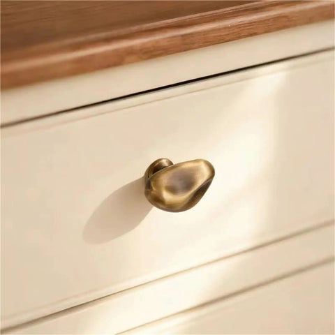 Antique Style Chrome Furniture Handles And Cabinet Knob Set for drawers, close-up of single knob on cream drawer, smooth finish.