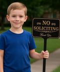 Child holding Heavy Duty No Soliciting Yard Sign With 37 Inch Adjustable Stake For Home And Biz 14 By 10 Inch Aluminum Sign