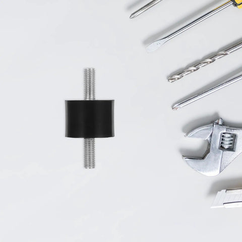 Four Piece Built For The Grind Anti Vibration Rubber Studs M10 Double Screw Mounts cylindrical shock absorber on a workshop table.