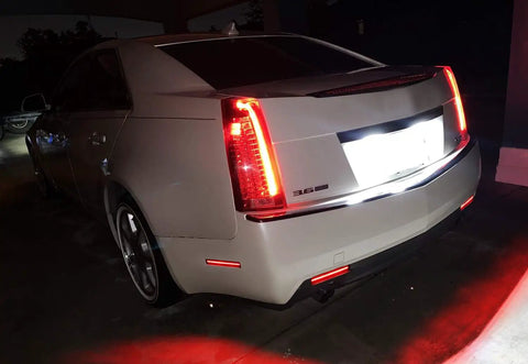 Rear view of a Cadillac CTS 2008-2013 with Smoked Red Full LED Rear Side Marker Light Kit, showing bright red lights and IP66 ABS housing.