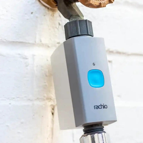Smart Hose Timer With Two Valves And One WiFi Hub App Controlled Outdoor Faucet Timer attached to wall