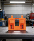 No Hands Free Electric Wire Welding Fixture With Adjustable Clamps For Precision Alignment, vibrant orange tool on a workbench.