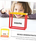 Child using Newton Cradle Balance Balls Kit For DIY Physics Experiments At Home Office Or Classroom Hands On Educational Toy To Demonstrate Momentum And Energy Conservation on table