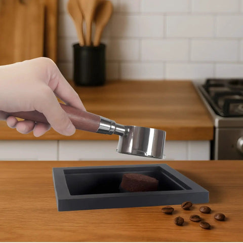 Hand holding portafilter over Stainless Steel Coffee Grounds Box for Espresso Machines, Black Bar Trash Bin With Rubber Bottomless Design
