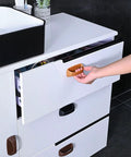 Peel and stick knob application on white cabinet drawer from 6 Pack Self Stick Cabinet Handles And Drawer Pulls With Adhesive, Drill Free Installation
