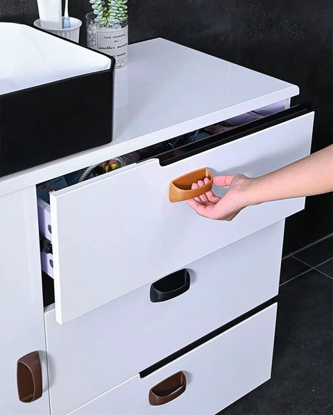 Peel and stick knob application on white cabinet drawer from 6 Pack Self Stick Cabinet Handles And Drawer Pulls With Adhesive, Drill Free Installation