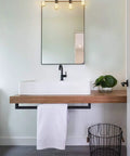 Farmhouse 4 light vanity light over mirror for bathroom with wood look back plate and metal accents retro vibe bath bar fixture