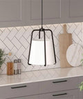 11 Inch Wide Pendant Light With Blackened Bronze Outer Frame And White Fabric Shade in a modern kitchen setting.