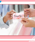 Hands exchanging a thank you card, linked to the Heart Shaped Handheld Punch Card Kit With 100 Reward Cards, home office use.